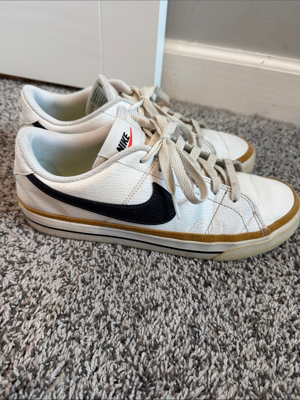 Nike Women's White Sneakers with Black Swoosh and Tan Trim